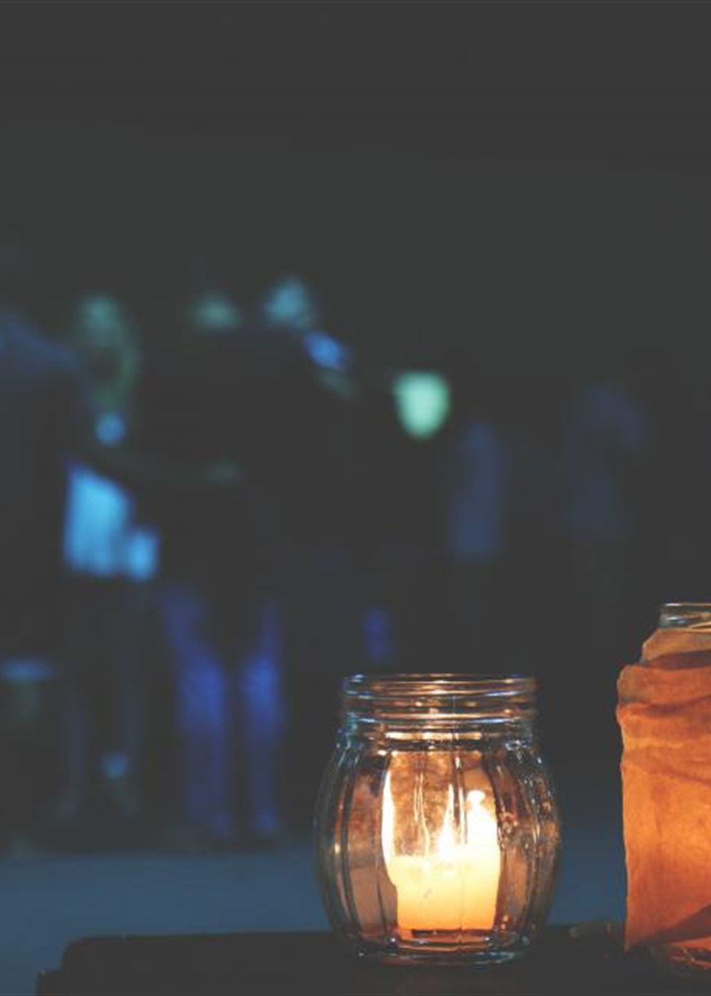 Candle jars glowing against a dark background