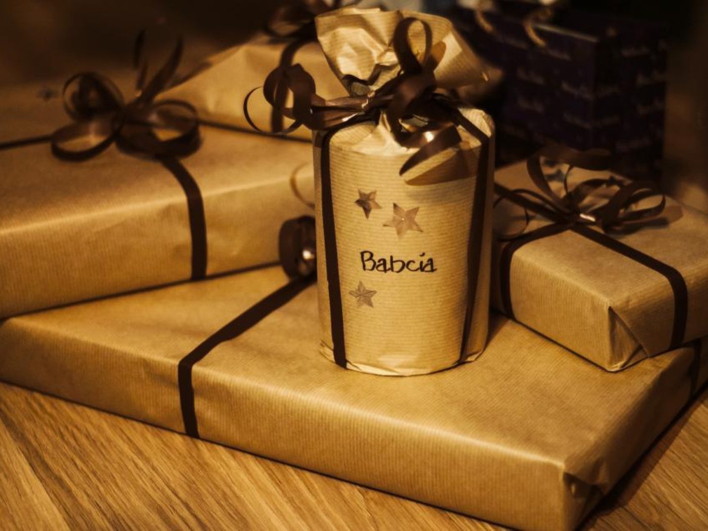 Gifts wrapped in kraft paper and gold ribbon