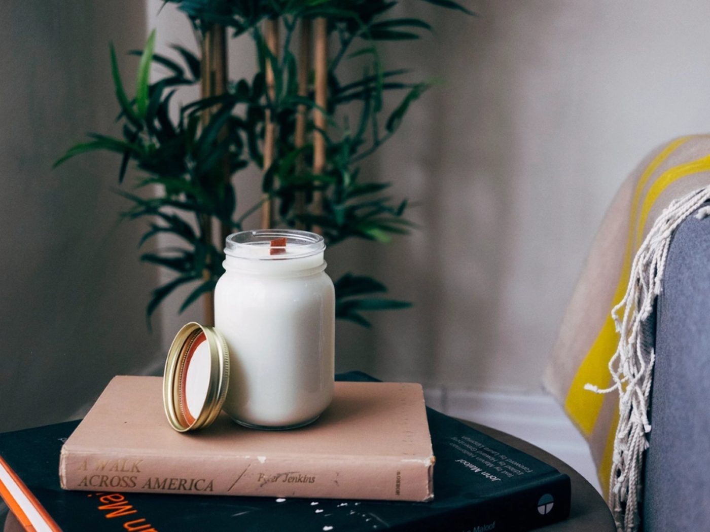 A candle resting on a stack of books