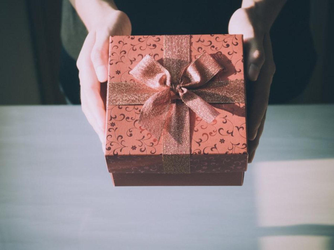 A wrapped gift box held in two hands
