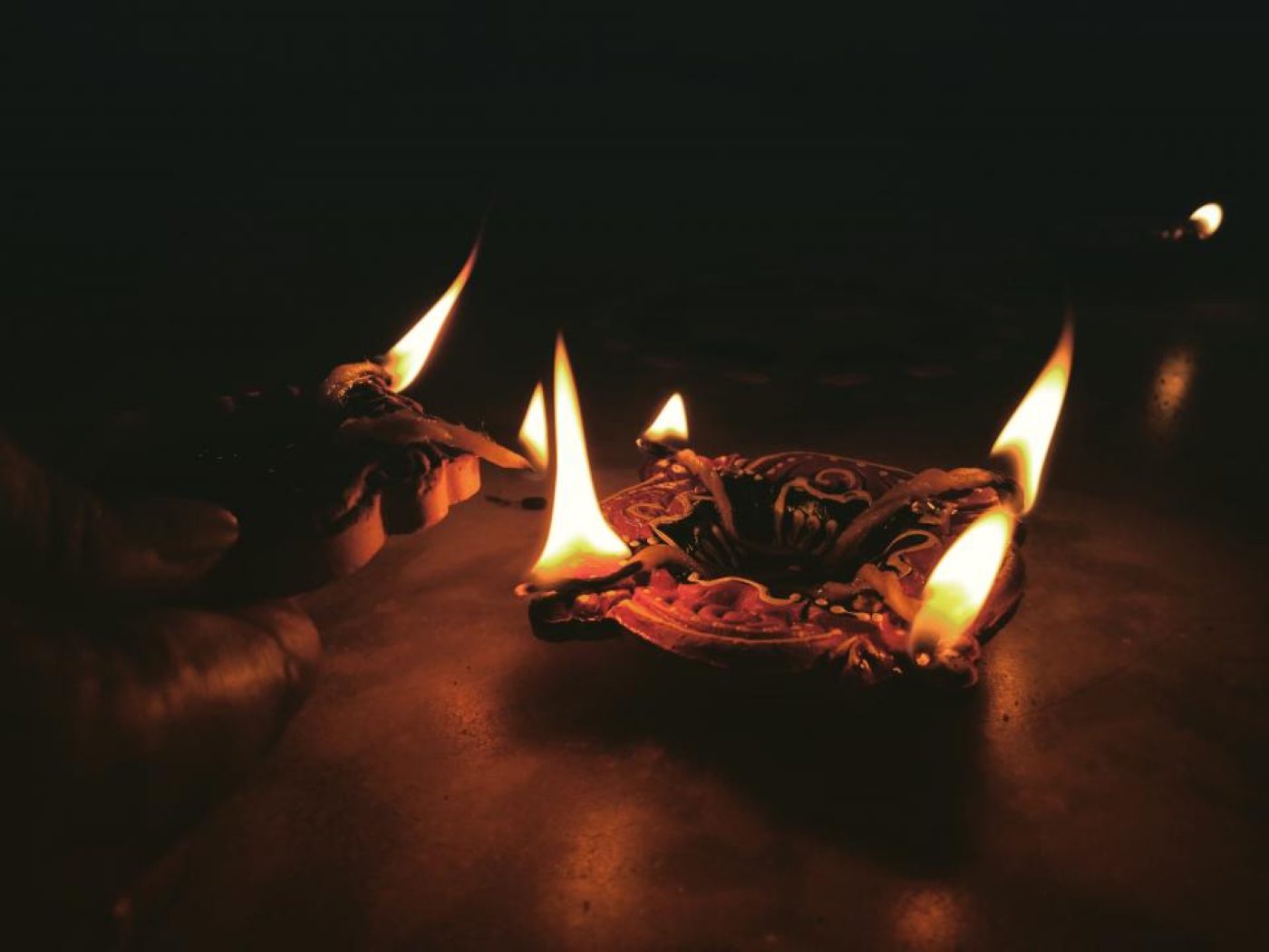Candle flames glowing warmly in the dark