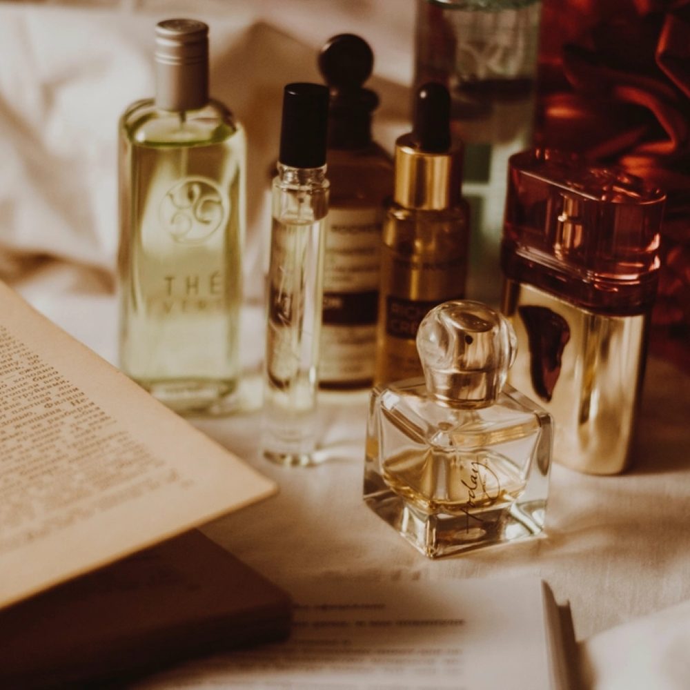 Fragrance bottles arranged in warm light