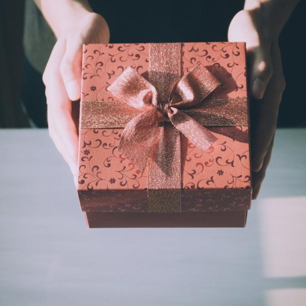 A wrapped gift box held in two hands