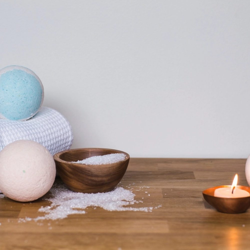 A towel, bowl and candle arranged for relaxation