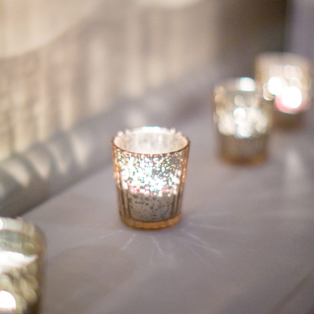 Tealight candles glowing in soft focus